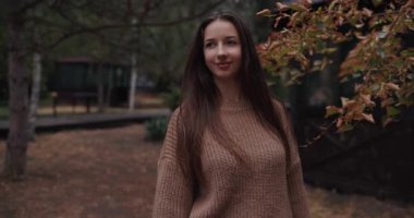 Young woman enjoy fall day walking in autumn park