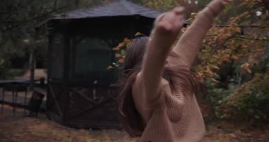 Young woman enjoy fall day walking in autumn park
