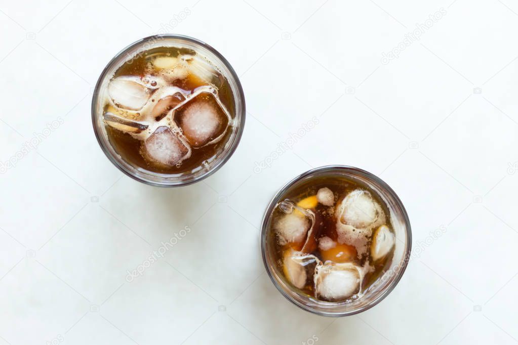 Cold brew. Coffee with ice on light background. Top view