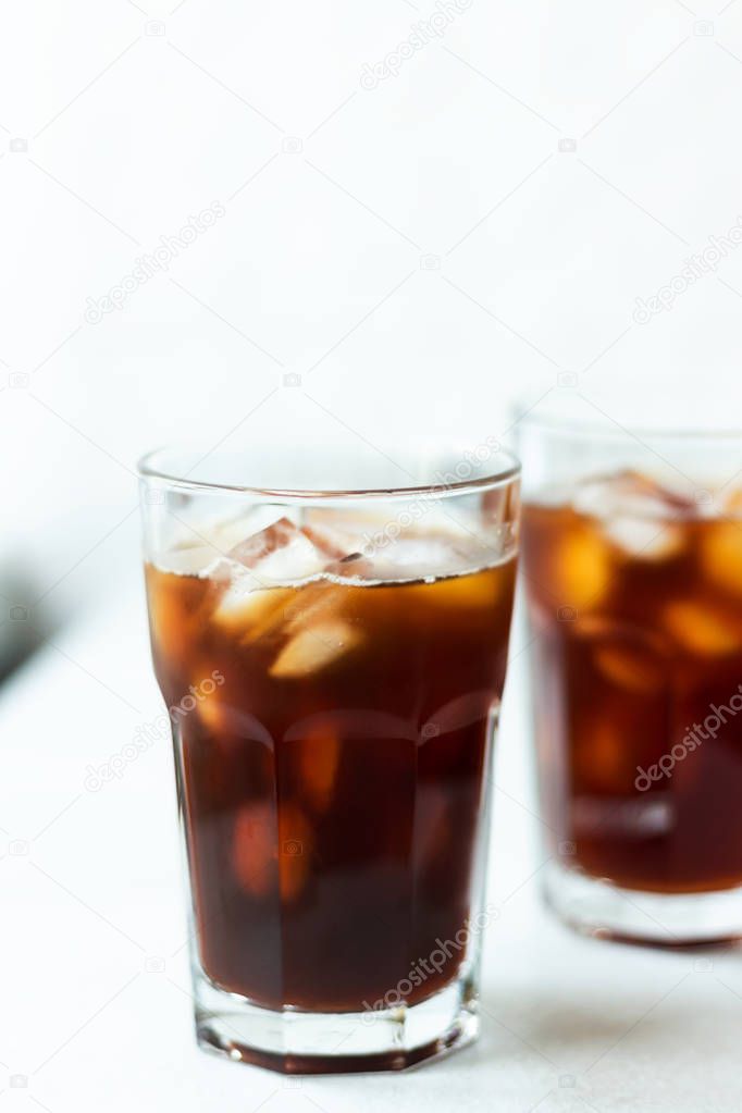 Cold brew with copy space. Coffee with ice on light background