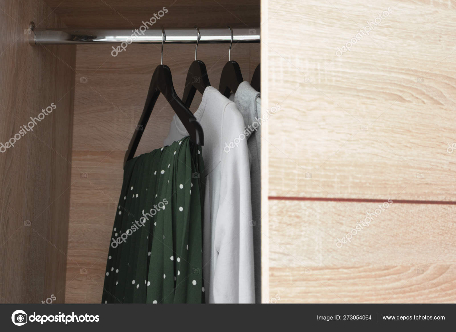 Open Wooden Wardrobe Closet With Clothes On Black Hanger Stock