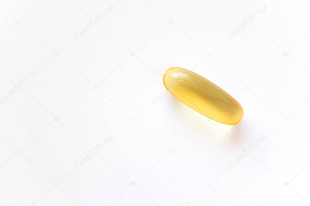 Capsule with fish oil on white background, close up