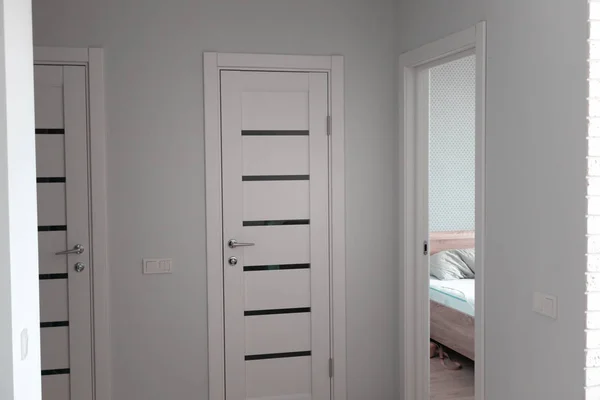 Apartment with white doors and entrance to bedroom