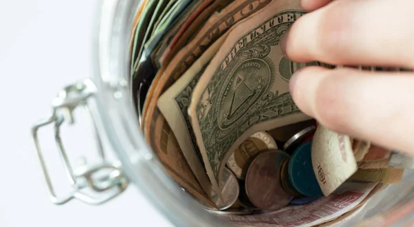 Hand pulls bill from the jar. Savings of money — Stock Photo, Image