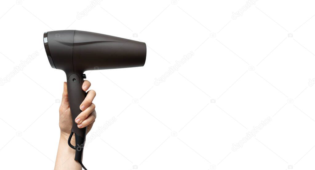 Woman hand holding hairdryer isolated on white background with copy space, horizontal. Haircare concept