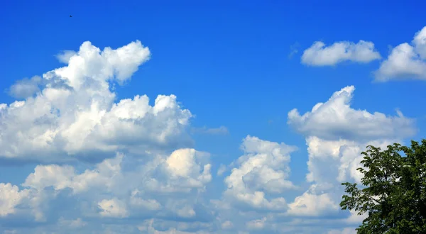 Blue sky with white clouds. Horizontal natural background.