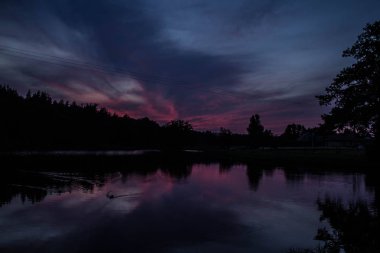 Göl ve orman üzerinde güzel pembe günbatımı! Arka plan.