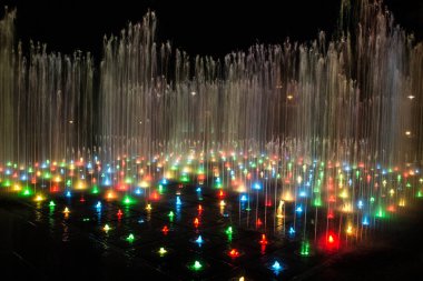 Gece aydınlatmalı renkli bir çeşme. Muhteşem bir çeşme. Arka plan.