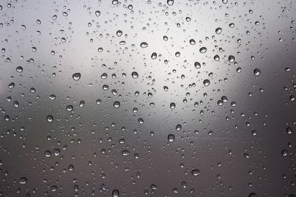 Raindrops on the glass. Raindrops on a sky background. Background. Texture.