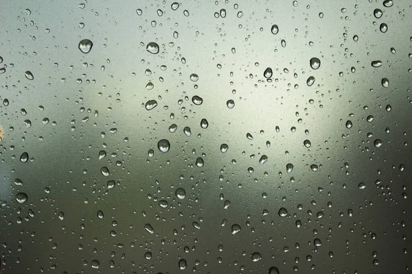 Raindrops on the glass. Raindrops on a sky background. Background. Texture.