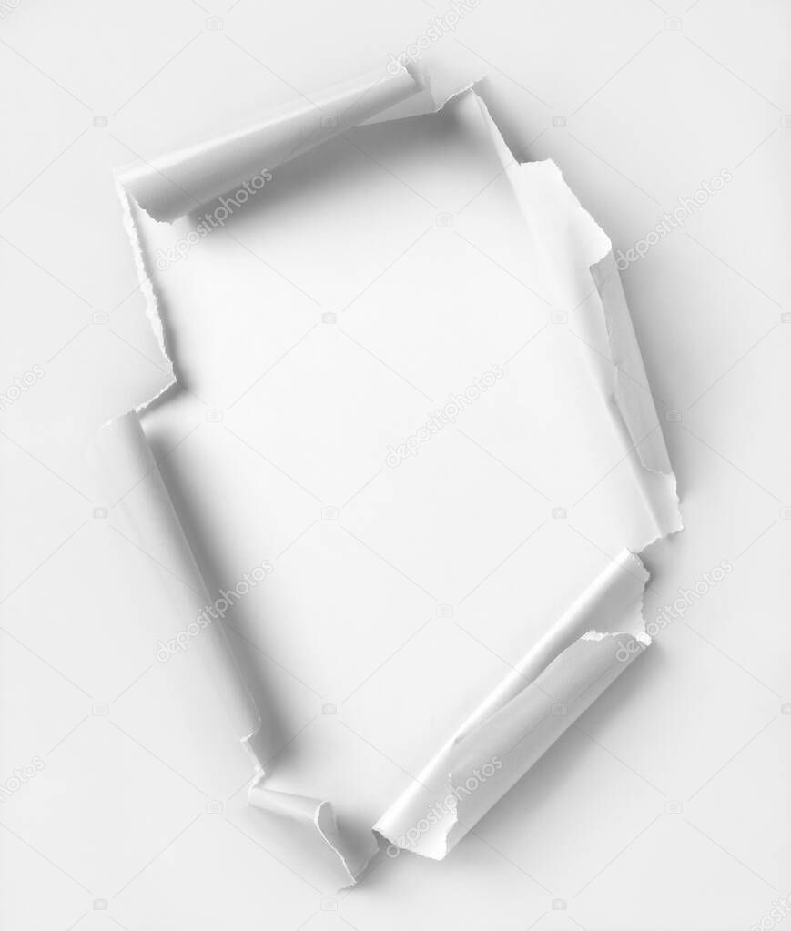 Hole ripped white color paper. White background. Clipping path inside hole