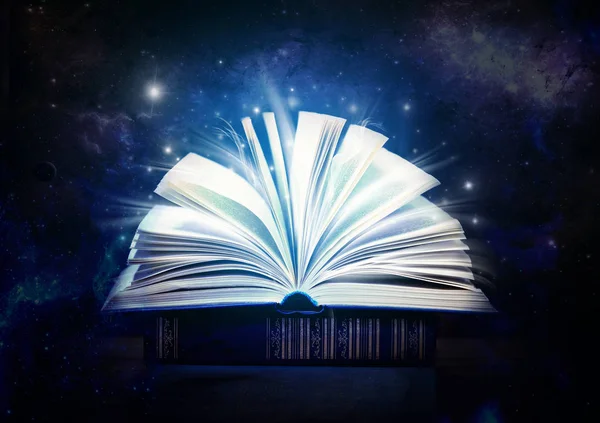 Glowing open book on wooden background