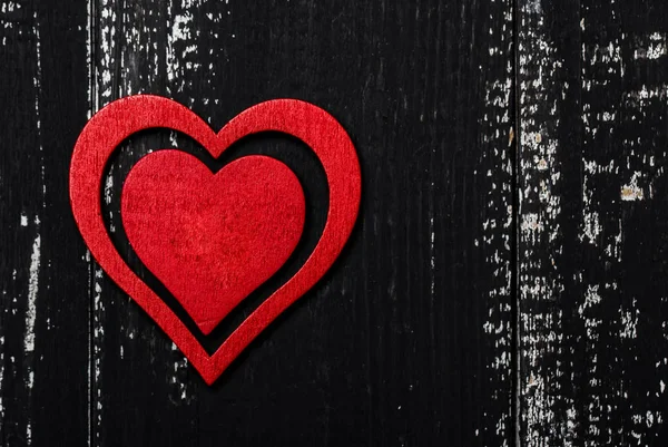 Wooden heart on dark grunge wooden background, valentine day concept