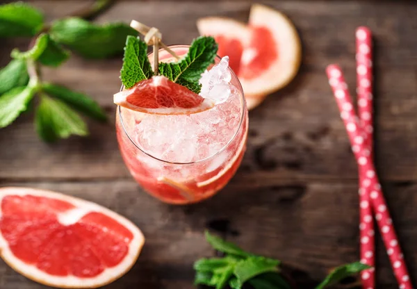 Fresh grapefruit cocktail. Fresh summer cocktail with grapefruit and ice cubes. Glass of grapefruit mojito