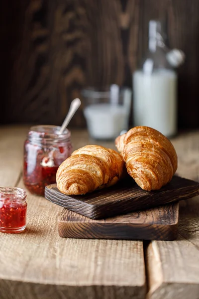 Appetizing croissants with sweet berry jam