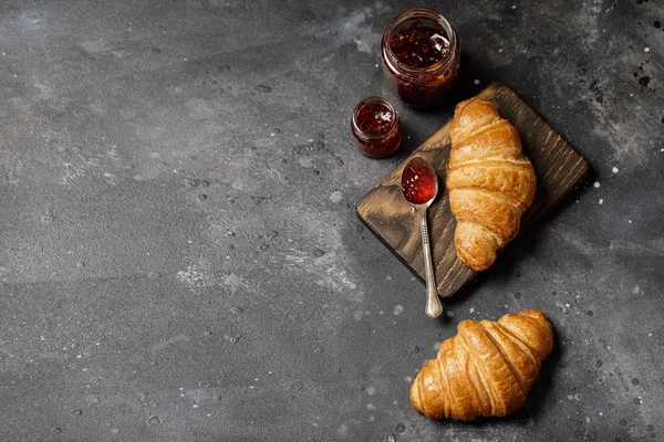 Appetizing croissants with sweet berry jam