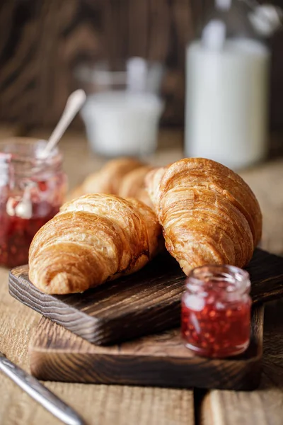 Appetizing croissants with sweet berry jam