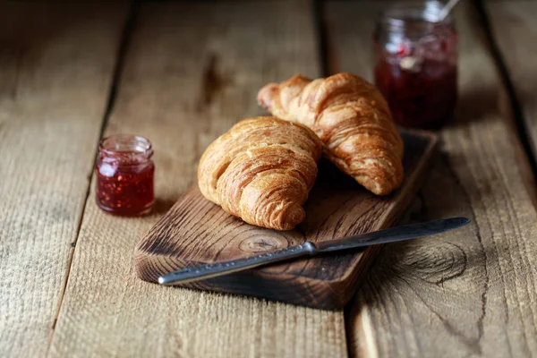 Appetizing croissants with sweet berry jam