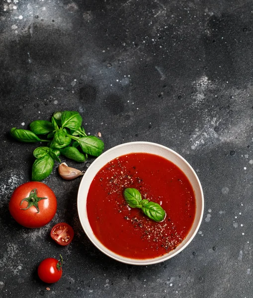 Tasty and appetizing cold gazpacho soup with basil leaves