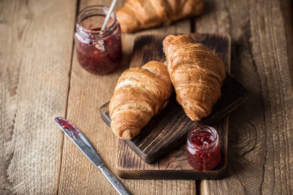 Appetizing croissants with sweet berry jam