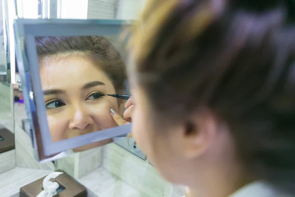 Primer plano retrato de hermosa chica tocando delineador de ojos negro en b —  Fotos de Stock