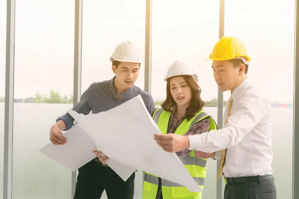 Instructor with young people in engineering training in construction on site work.