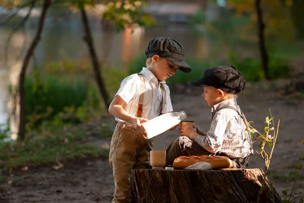 Çocuklar ormanda ekmek ve süt yiyorlar.