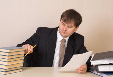 Employee counts books with documents at the table in the office clipart