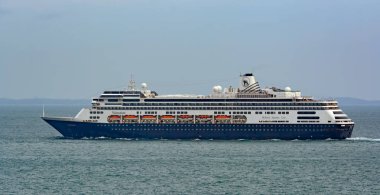 SINGAPORE - Jan 31, 2017: R-Class cruise passenger ship 'Volendam' in Singapore Strait. The ship was built in 1999 and operated by Holland America Line as a subsidiary company of Carnival Cruise Lines clipart