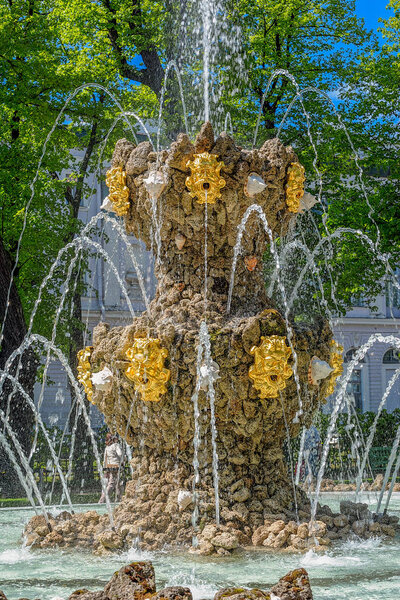 ST.PETERSBURG, RUSSIA - June 07, 2017: Fountain Koronny (Crown, 1725 by Mikhail Zemtsov) and ancient sculptures in the antique city's park Summer Garden (Letniy sad) in Saint-Petersburg, Russia