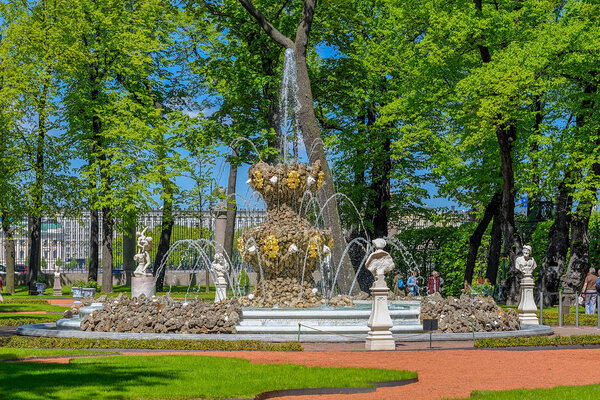 ST.PETERSBURG, RUSSIA - June 07, 2017: Fountain Koronny (Crown, 1725 by Mikhail Zemtsov) and ancient sculptures in the antique city's park Summer Garden (Letniy sad) in Saint-Petersburg, Russia