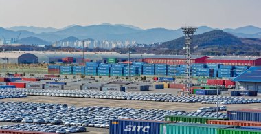 GWANGYANG, SOUTH KOREA - Feb 18, 2017: Rows of new cars waiting to be dispatch and shipped around the world from the cargo port in South Korea. clipart