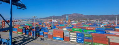 GWANGYANG, SOUTH KOREA - Feb 18, 2017: Panorama of shipping containers stacked at the Gwangyang Container Terminal. clipart