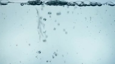 Şeffaf cam Stream küçük kabarcıklar ile saf temiz soğuk su dökme, yakın çekim, yan görüş açısı, ağır çekim düşük