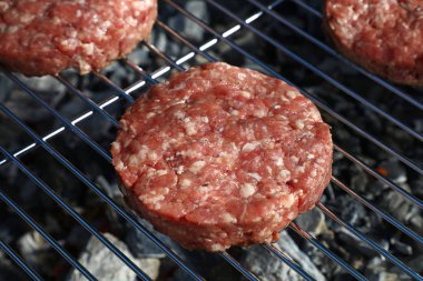 Çiğ sığır eti ya da domuz eti barbeküsü hamburgerler için ızgarada pişirilmiş, yüksek açılı ızgara.