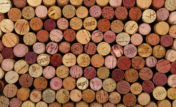 Close up background pattern of many assorted stacked used red wine corks