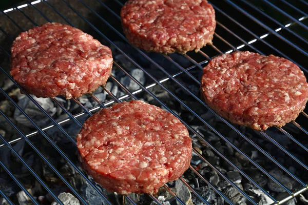 Raw beef burger for hamburger on barbecue grill