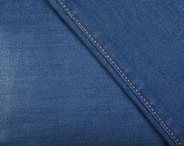 Blauwe jeans van gewassen denim textuur achtergrond — Stockfoto