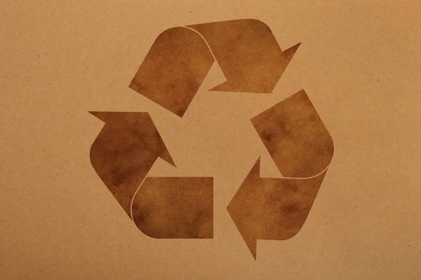 Brown paper background with recycling logo sign