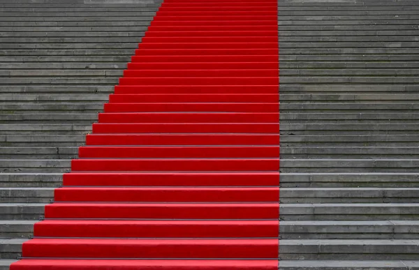 Red carpet over concrete stairs perspective