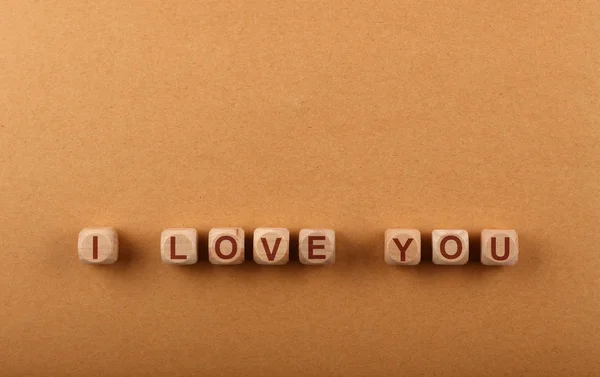 Wooden cubes with I LOVE YOU words over red — Stock Photo, Image