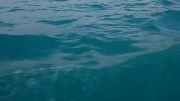 Крупный план ярко-голубых волн морской воды на борту судна во время плавания персональной камеры — стоковое видео