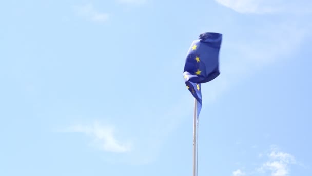 Close up flag of EU waving in wind over blue sky — Stock Video