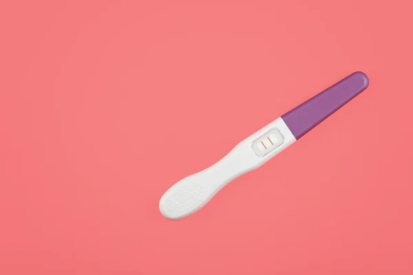 Närbild positivt graviditetstest över rosa — Stockfoto