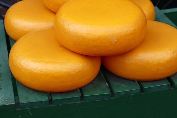 Close up big wheels of hard gouda cheese — Stock Photo, Image