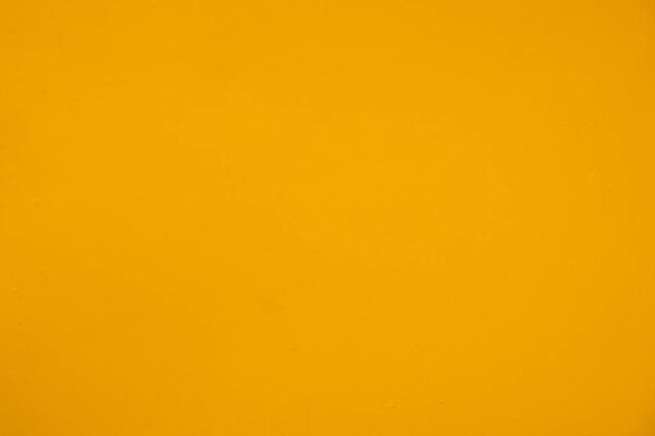 Uneven vivid yellow painted metal background