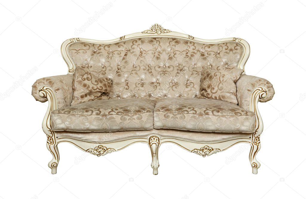 Beige tufted retro Chesterfield style sofa with couch pillows isolated over white background, low angle, front view