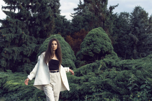 Young brunette in stylish modern clothes