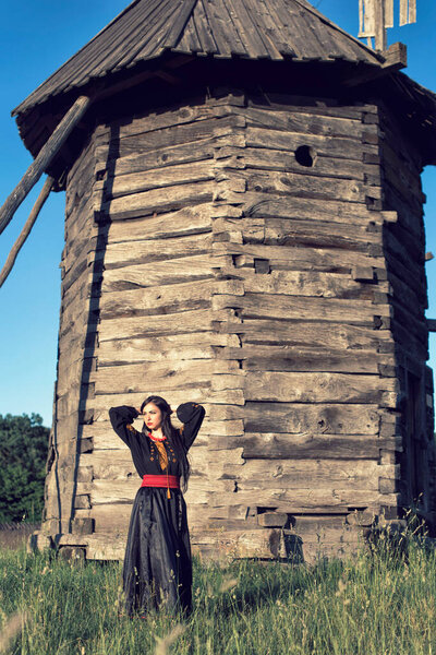 Young girl among old wooden buildings