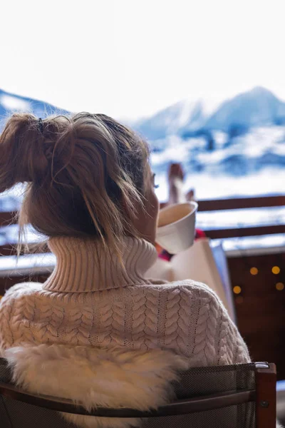 Morning chill out on the fresh mountains air, cheerful woman holding in her henads a cup of tasty coffee that gives her enerfy for the whole busy day.Travel around the Europe, visit a lot of countries